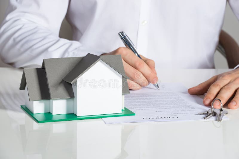Businessman Signing House Contract stock photography