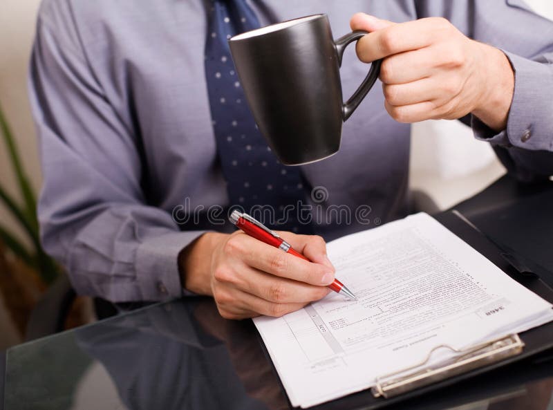 Businessman signing papers stock photography