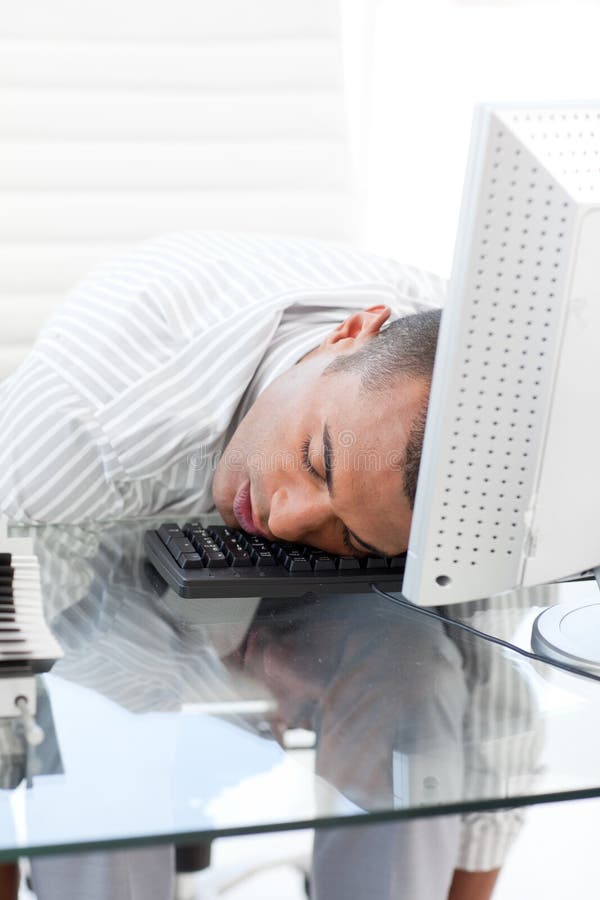 Businessman sleeping on a keyboard in the office