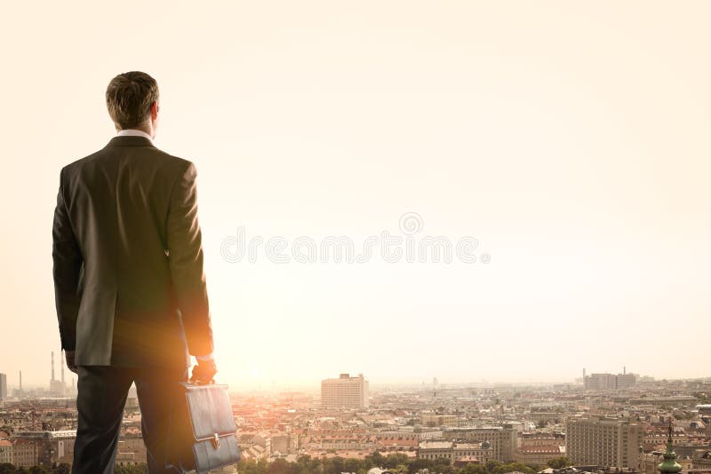Businessman standing with back against city stock images