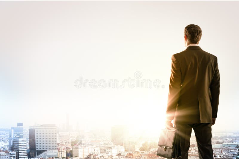 Businessman standing with back against city royalty free stock photography