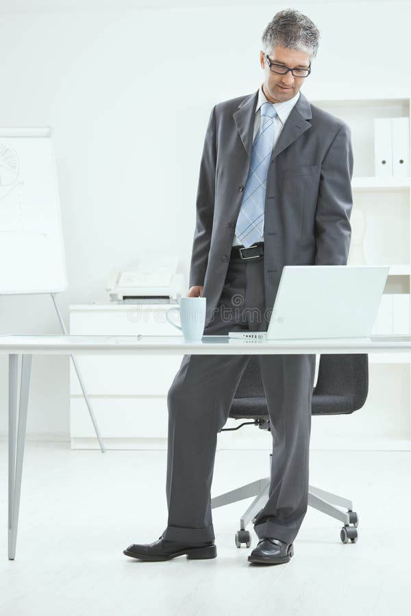 Businessman Standing at Desk Stock Photo Image of good