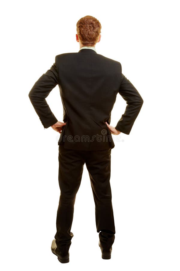 Businessman in a suit from the back with arms akimbo