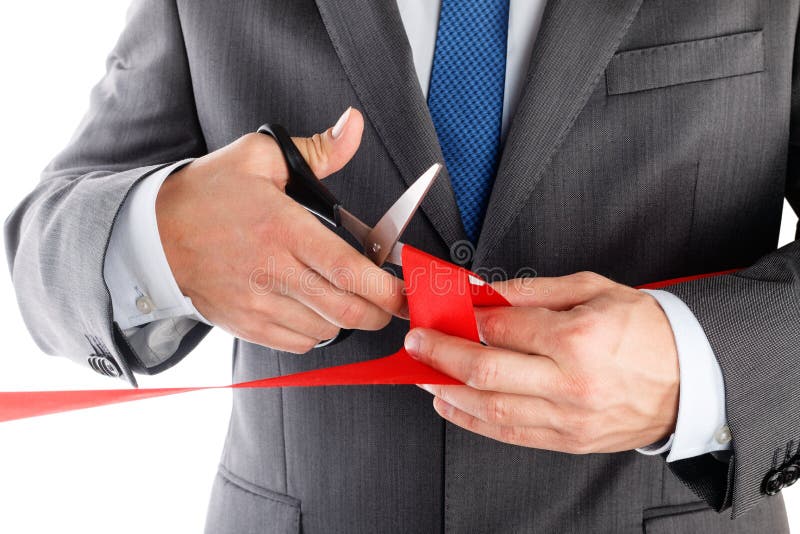 Businessman in suit cutting red ribbon with pair of scissors iso royalty free stock photos Businessman in suit cutting red ribbon with pair of scissors iso royalty free stock photos