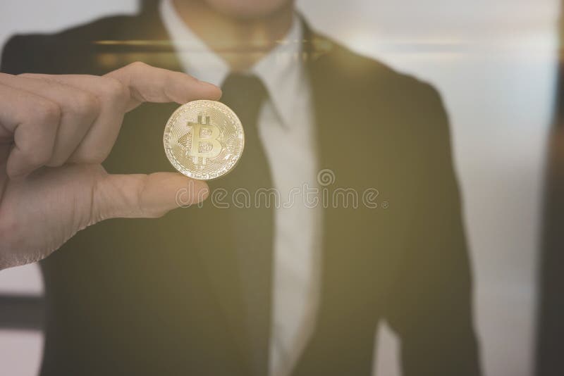 Businessman Holding Bitcoin Golden Coin. Symbol of Crypto Currency ...