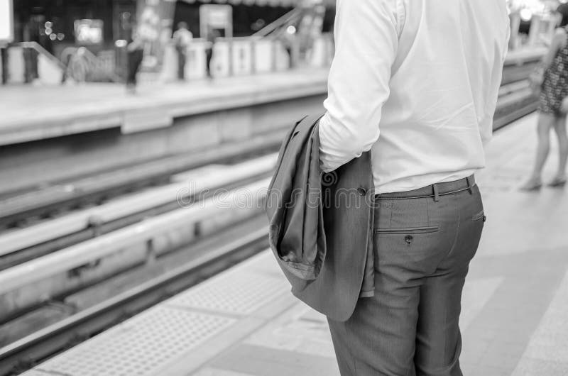 Businessman with Suit at Train Station Black and White Tone. Stock