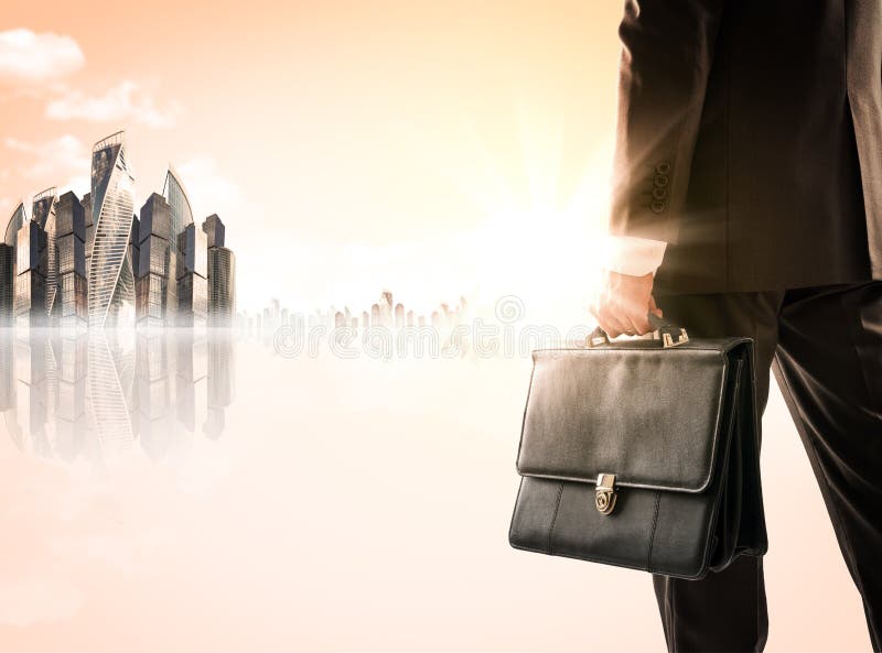 Businessman with suitcase against modern city stock images