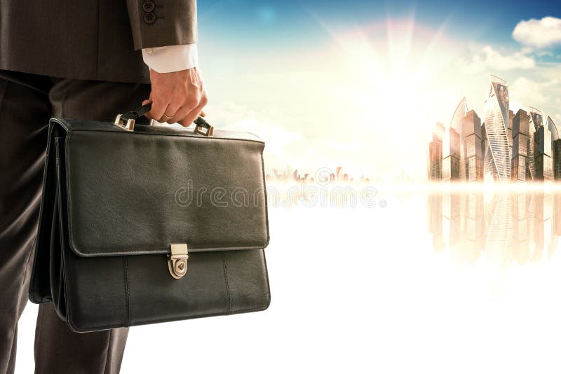 Businessman with suitcase against modern city royalty free stock images