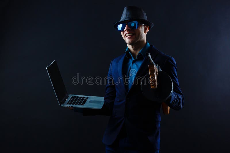 Businessman in Sunglasses with Machine Gun and Laptop Stock Image