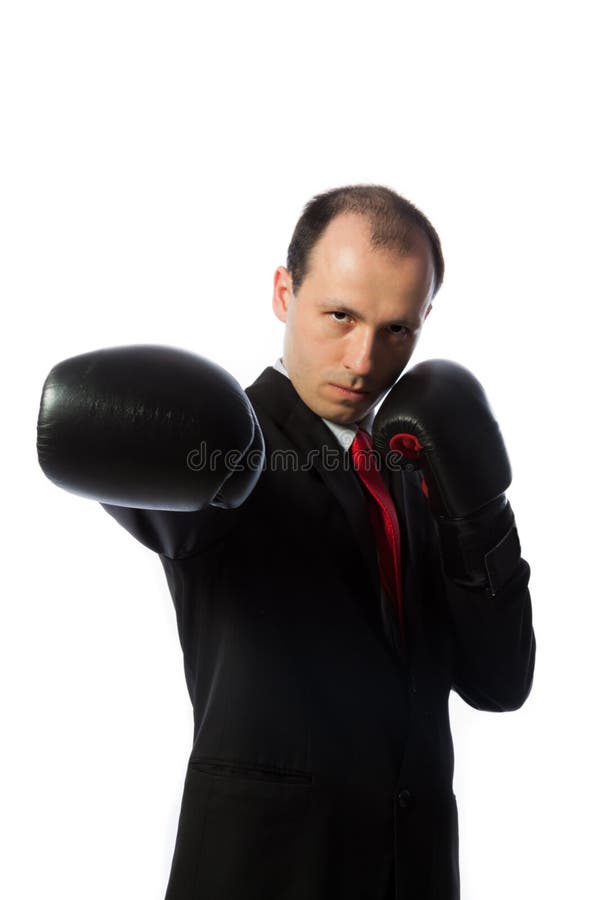 Businessman with a tie and boxing gloves punching