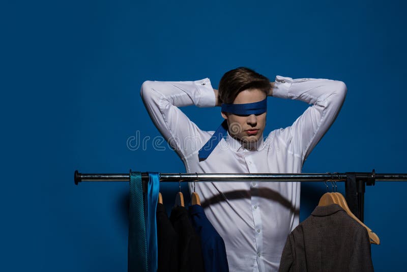Blind Way of Life. Blindfolded Man with Tie on Eyes in White Shirt