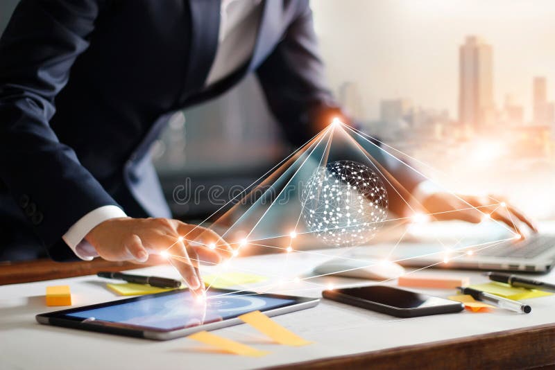 Businessman touching tablet and laptop. Managing data exchange stock photography Businessman touching tablet and laptop. Managing data exchange stock photography