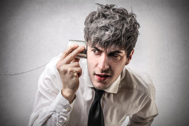 Businessman trying to listen to something