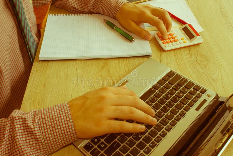 Businessman using a calculator to calculate the numbers royalty free stock photography