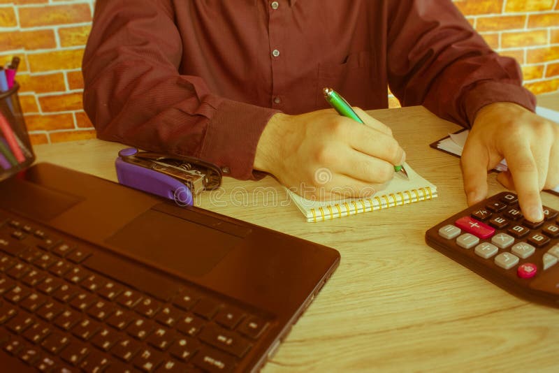Businessman using a calculator to calculate the numbers stock photos