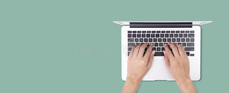 Businessman using laptop computer  on green background, business man typing keyboard on notebook with copyspace.