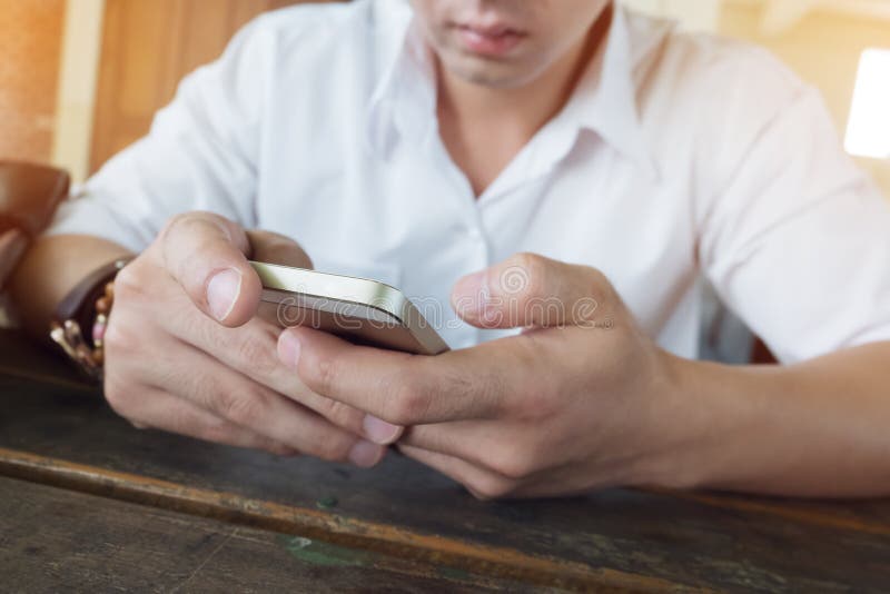 Businessman using a mobile phone with texting message stock photo