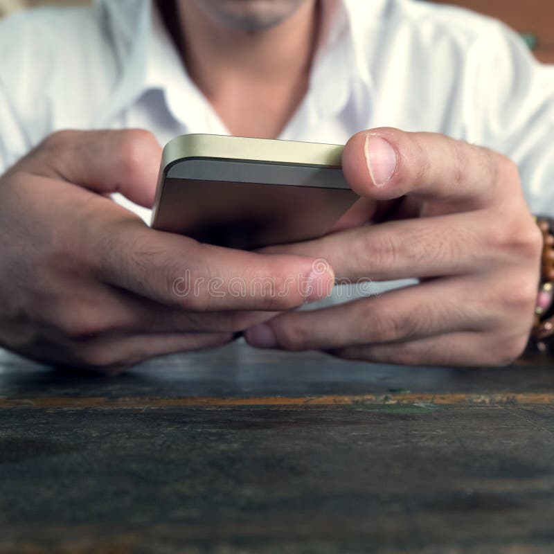 Businessman using a mobile phone with texting message stock images