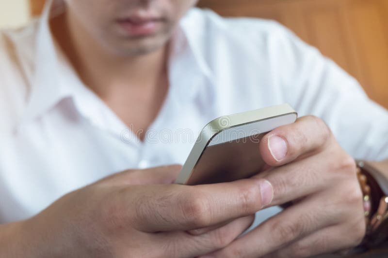 Businessman using a mobile phone with texting message stock image