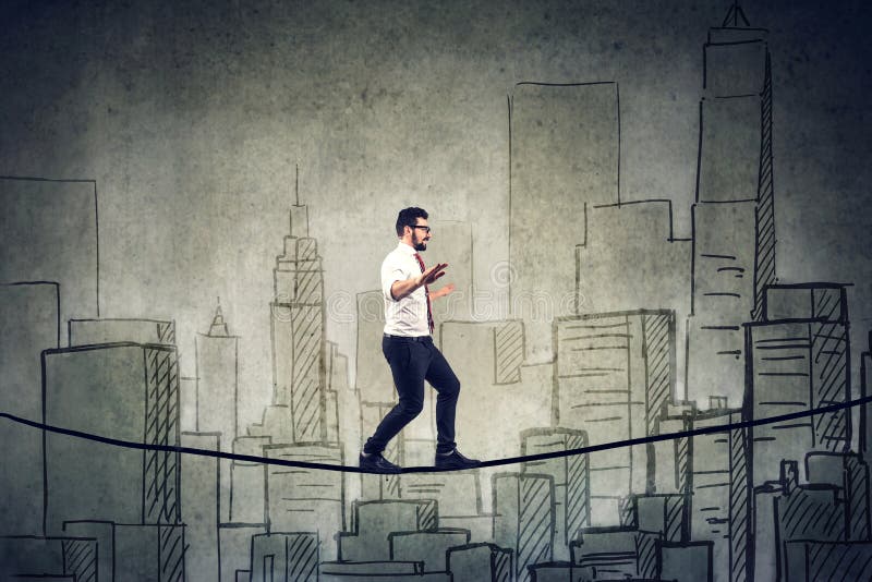 Businessman walking balancing on a rope above a city royalty free stock photography Businessman walking balancing on a rope above a city royalty free stock photography
