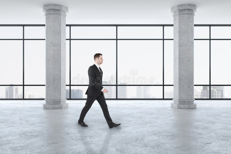 Businessman walking in modern gallery interior