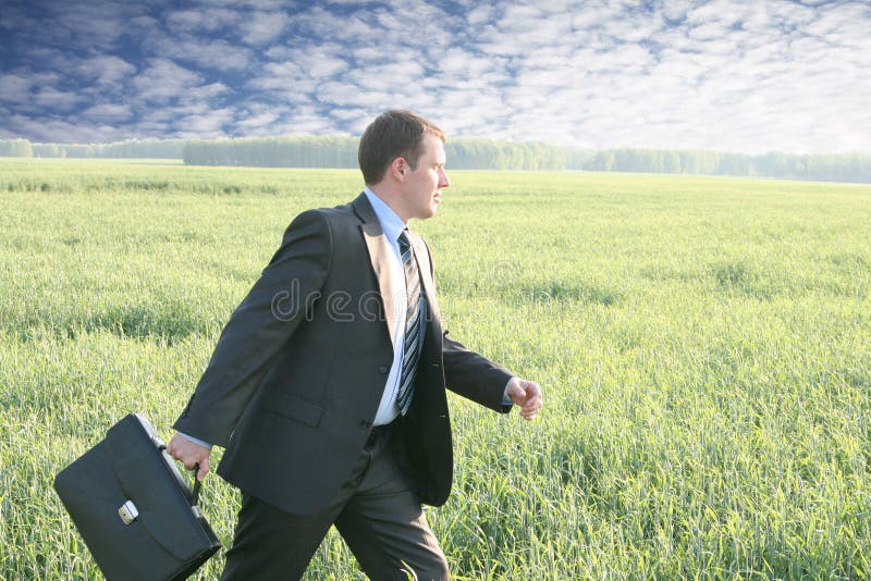 Businessman walks with suitcase