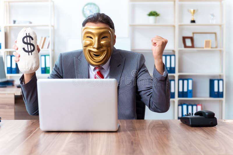 Businessman wearing mask in hypocrisy concept stock images Businessman wearing mask in hypocrisy concept stock images