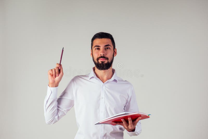 Businessman in white collar shirt with pen and notepad . in a studio. concept of business coach inspiration and ideas