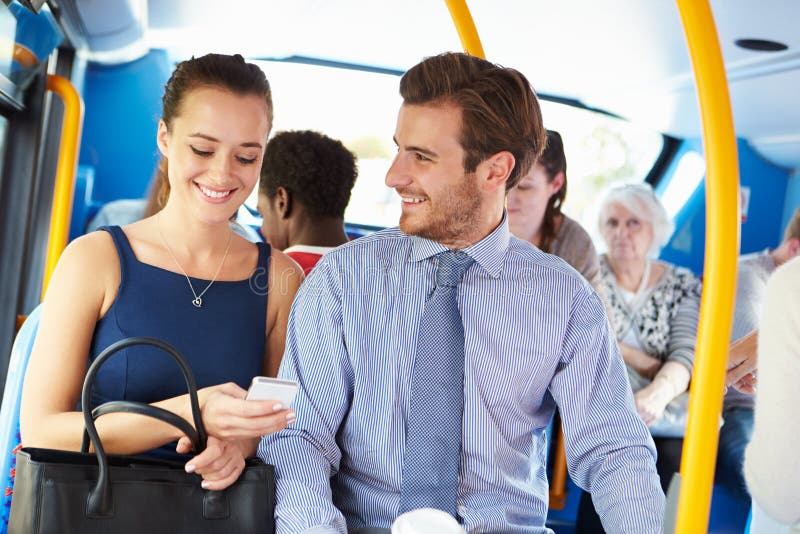 Businessman And Woman Looking At Mobile Phone On Bus royalty free stock photography Businessman And Woman Looking At Mobile Phone On Bus royalty free stock photography