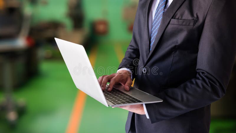 Closeup businessman manager working on laptop computer to check inventory stock order in warehouse factory workshop. Business, industy, manufacturing concept, spark, building, chain, construction, control, customer, delivery, distribution, e-commerce, energy, engineering, equipment, export, fire, growth, import, industrial, industry, investments, job, labor, laborer, light, management, managers, manufacture, mask, people, plan, power, protection, safety, services, shipping, skill, steel, store, supply, transport, welder, welding, worker. Closeup businessman manager working on laptop computer to check inventory stock order in warehouse factory workshop. Business, industy, manufacturing concept, spark, building, chain, construction, control, customer, delivery, distribution, e-commerce, energy, engineering, equipment, export, fire, growth, import, industrial, industry, investments, job, labor, laborer, light, management, managers, manufacture, mask, people, plan, power, protection, safety, services, shipping, skill, steel, store, supply, transport, welder, welding, worker