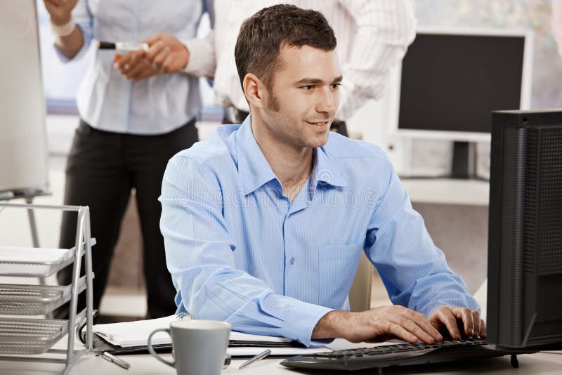 Businessman working on computer stock images