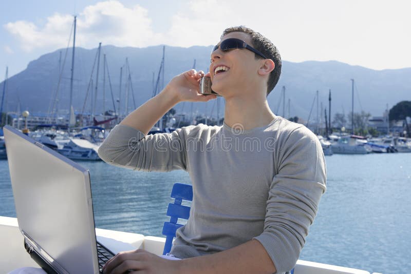 Businessman working with computer on a boat royalty free stock photo