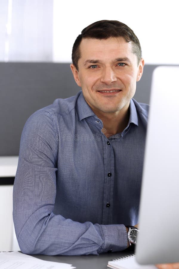 Businessman working with computer in modern office. Headshot of male entrepreneur or company director at workplace royalty free stock photos