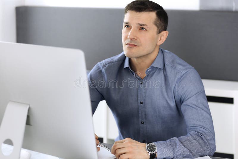Businessman working with computer in modern office. Headshot of male entrepreneur or company director at workplace royalty free stock photo