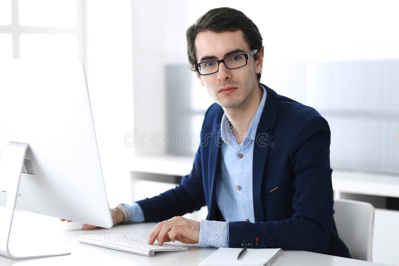 Businessman working with computer in modern office. Headshot of male entrepreneur or company manager at workplace stock photos