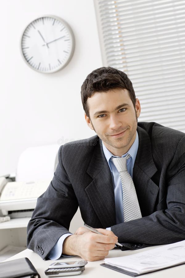 Businessman working at desk stock images