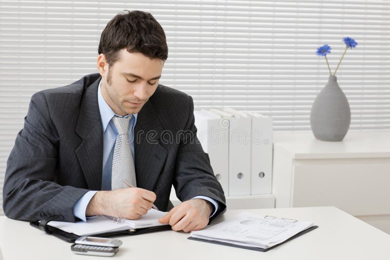 Businessman working at desk stock photography