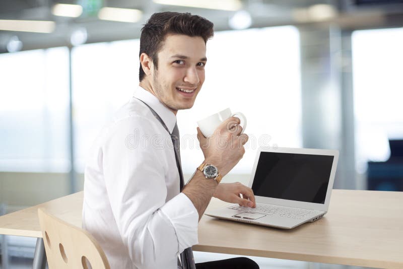 Businessman working on laptop and drink coffee royalty free stock photo