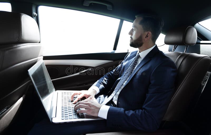 Businessman working with laptop sitting in car royalty free stock images Businessman working with laptop sitting in car royalty free stock images