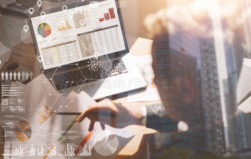 Businessman working at office on laptop.Man holding paper documents in hands.Concept of digital screen,virtual connection icon,diagram,graph interfaces on background.Double exposure,closeup