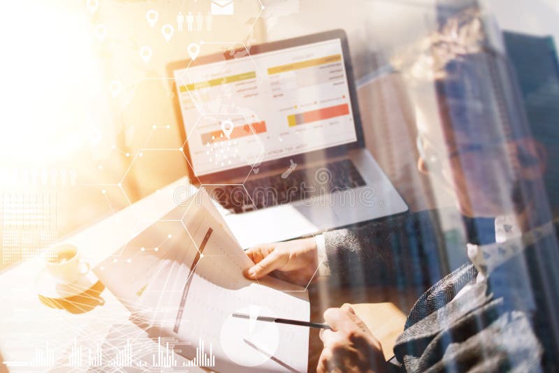 Businessman working at office on laptop.Man holding paper documents in hands.Concept of digital screen,virtual connection icon,diagram,graph interfaces on background.Double exposure,visual effects