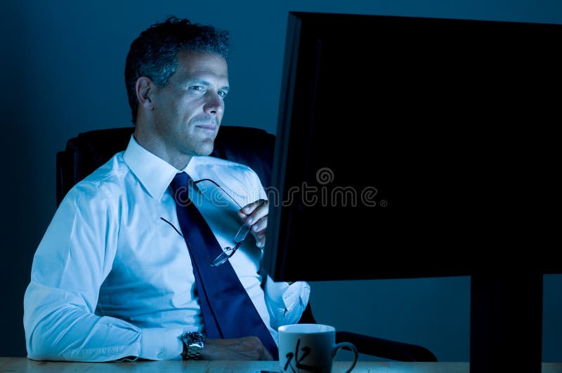 Businessman working till late royalty free stock images