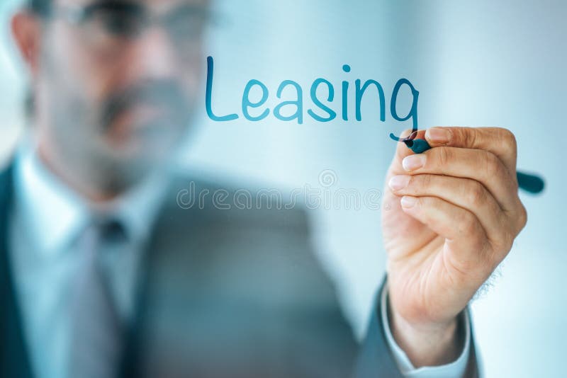 Businessman write the word Leasing and give a brief property, buildings, vehicles are common assets that are leased. royalty free stock images Businessman write the word Leasing and give a brief property, buildings, vehicles are common assets that are leased. royalty free stock images