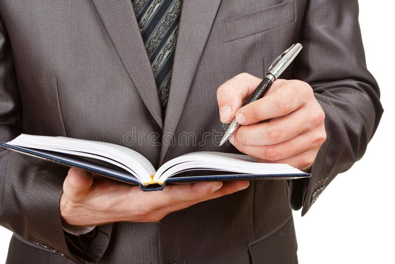 Businessman writing in business diary