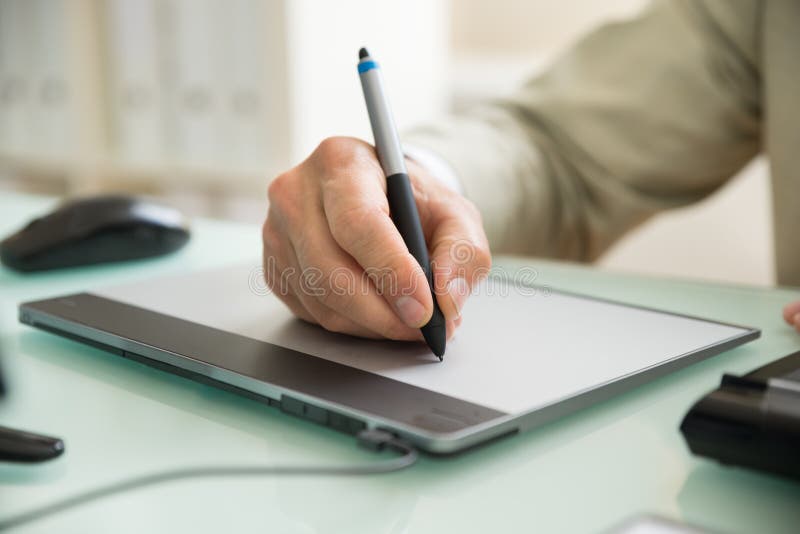 Businessman writing on graphic tablet