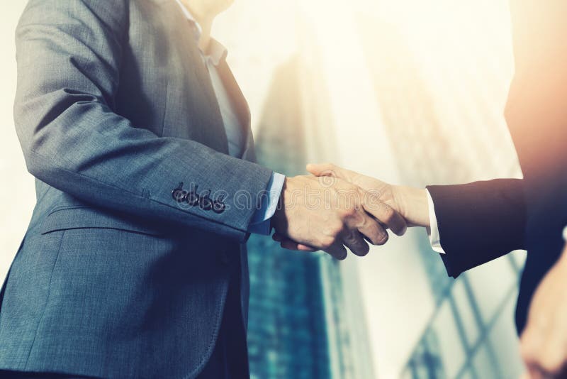 Businessmen meeting and handshake in front of business center