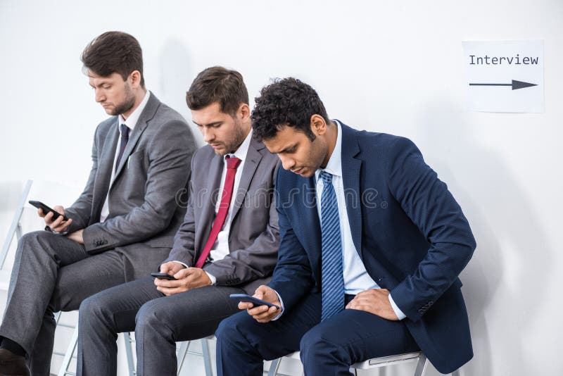 Businessmen sitting in queue and waiting for interview in office