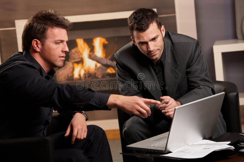 Businessmen using laptop computer