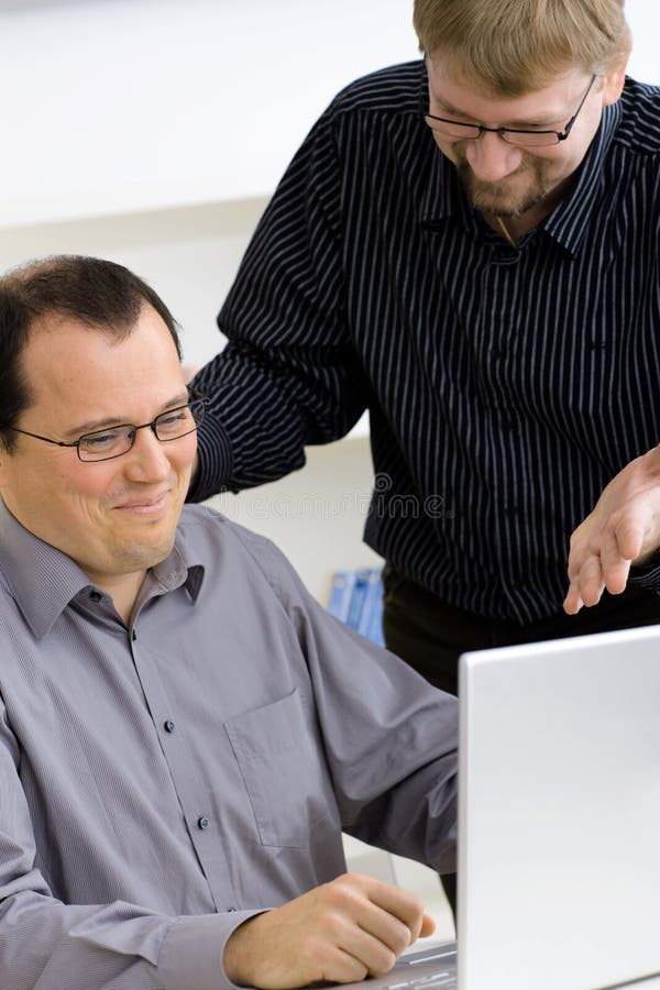 Businessmen using laptop computer