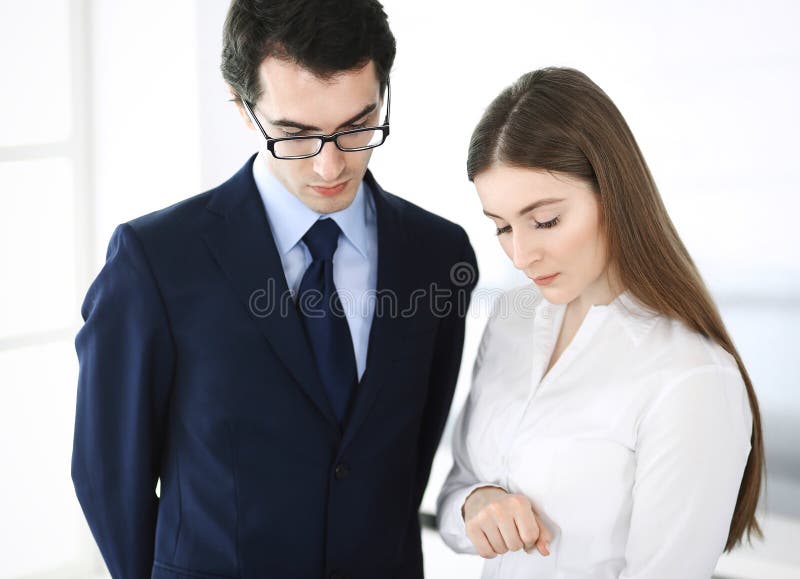Businessmen and woman using tablet computer in modern office. Colleagues or company managers at workplace. Partners stock photo Businessmen and woman using tablet computer in modern office. Colleagues or company managers at workplace. Partners stock photo